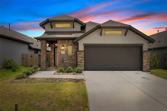 view of front of home featuring a garage and a yard