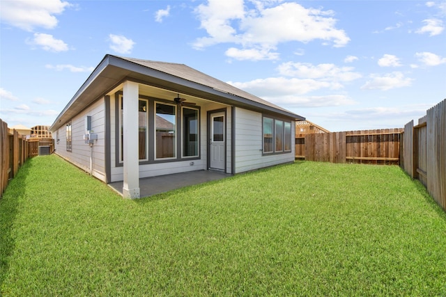 rear view of property featuring a patio area and a lawn