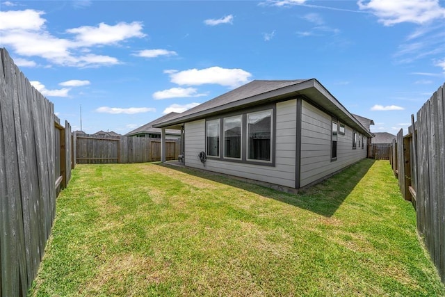 rear view of property with a lawn