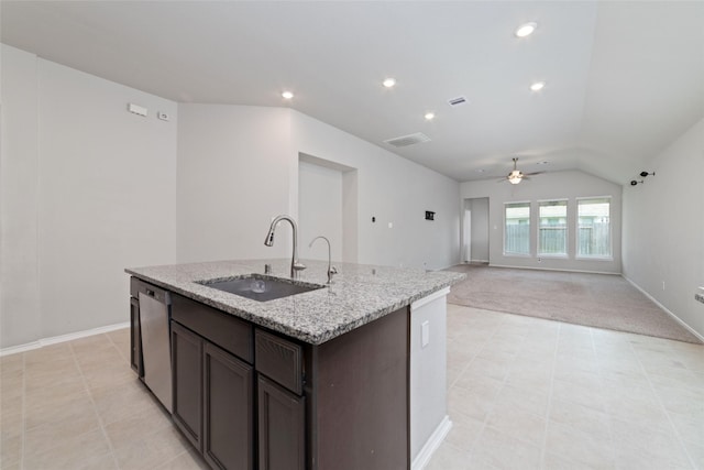 kitchen featuring dark brown cabinetry, dishwasher, sink, vaulted ceiling, and a center island with sink