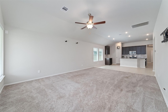 unfurnished living room featuring ceiling fan, light carpet, and lofted ceiling