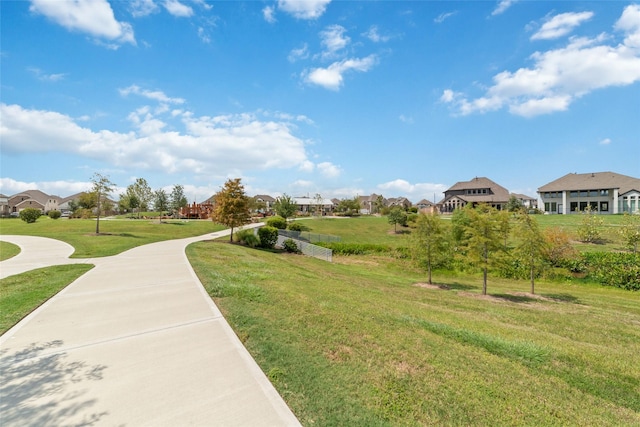 view of property's community featuring a yard