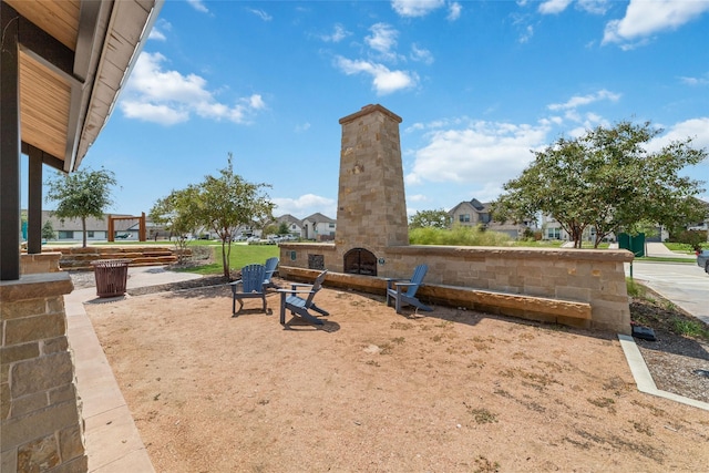 view of yard with an outdoor stone fireplace