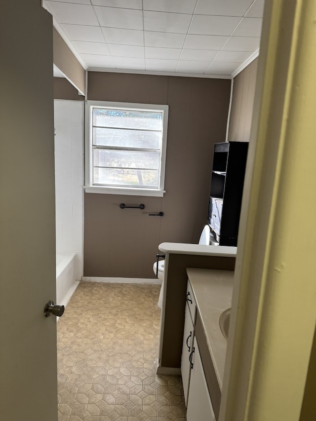 bathroom with vanity, toilet, and a tub