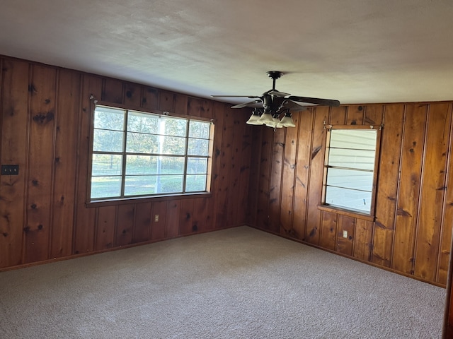 unfurnished room with ceiling fan and light carpet