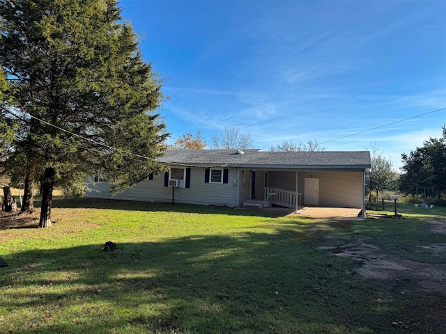 rear view of house featuring a lawn