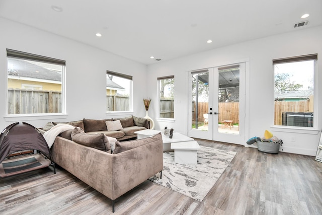 living room with french doors and light hardwood / wood-style flooring