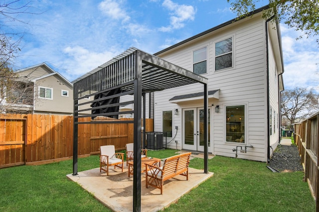 back of property with french doors, a yard, central AC, and a patio area