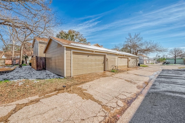 view of home's exterior with a garage and an outbuilding