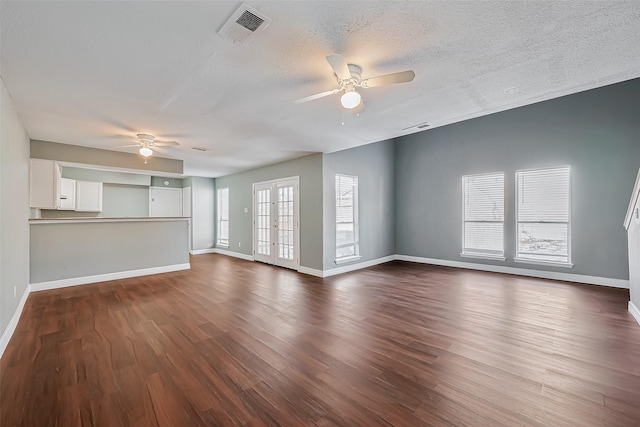 unfurnished living room featuring french doors, a textured ceiling, ceiling fan, and dark hardwood / wood-style flooring