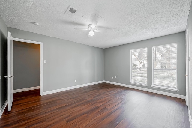 spare room with ceiling fan, dark wood-type flooring, and a textured ceiling