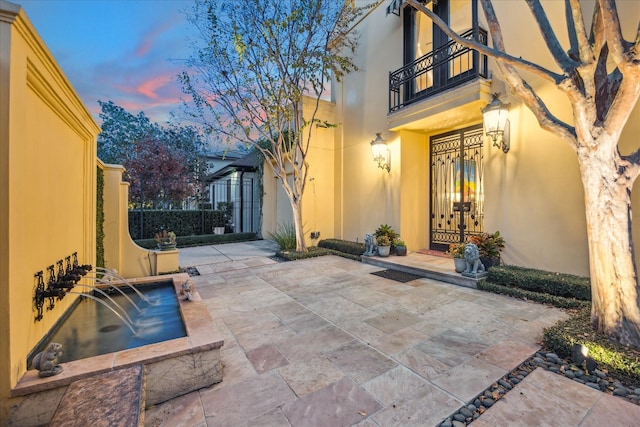 patio terrace at dusk with a balcony