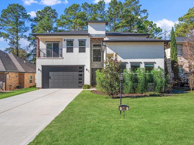 contemporary home with a balcony, a garage, and a front yard