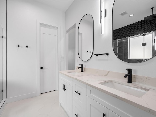 bathroom with tile patterned flooring, an enclosed shower, and vanity