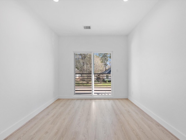 spare room featuring light hardwood / wood-style flooring