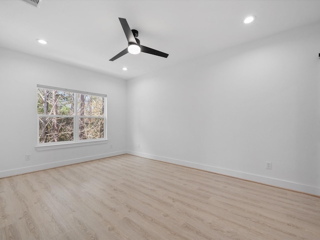 spare room featuring ceiling fan and light wood-type flooring