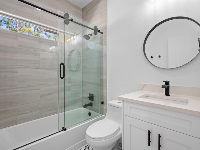 full bathroom with enclosed tub / shower combo, toilet, and vanity