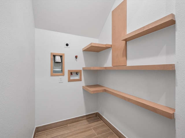 washroom featuring washer hookup, gas dryer hookup, electric dryer hookup, and light hardwood / wood-style floors