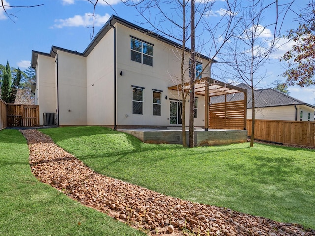 rear view of house with a patio area and a lawn