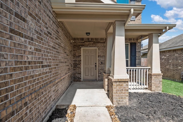 view of exterior entry featuring a porch