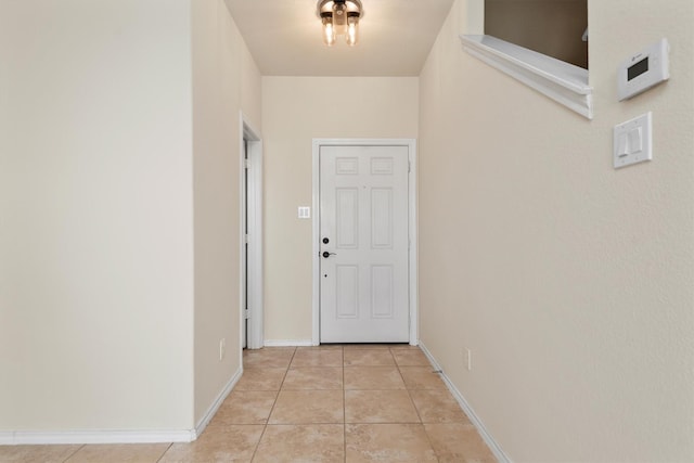 doorway with light tile patterned flooring