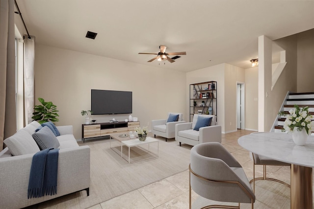 tiled living room featuring ceiling fan