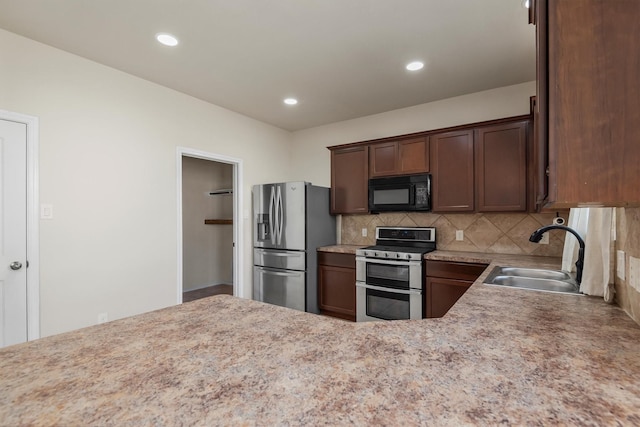 kitchen with sink, dark brown cabinetry, appliances with stainless steel finishes, and decorative backsplash