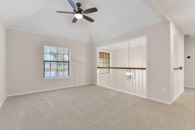 unfurnished room with ceiling fan with notable chandelier, light colored carpet, vaulted ceiling, and ornamental molding