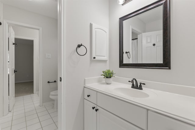 bathroom with toilet, tile patterned flooring, and vanity