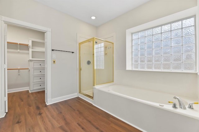 bathroom with wood-type flooring and plus walk in shower