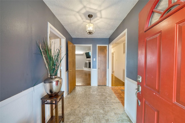 entryway with a textured ceiling