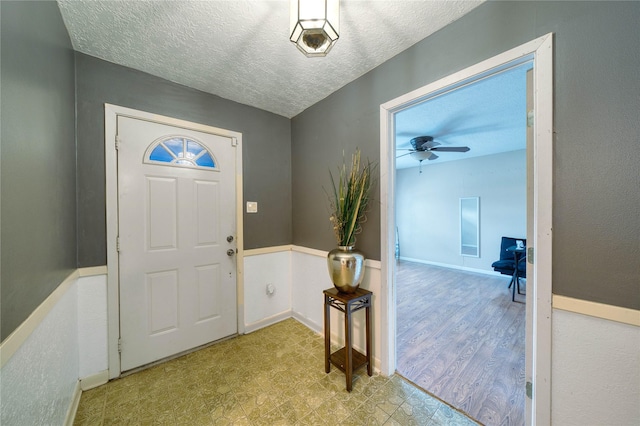 entrance foyer with a textured ceiling and ceiling fan