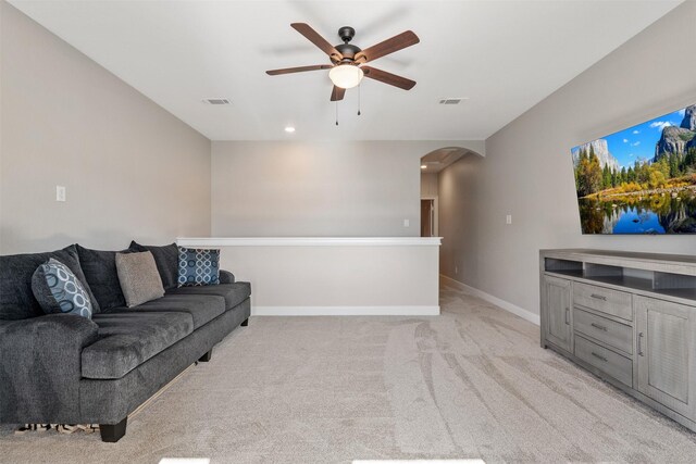 carpeted living room with ceiling fan