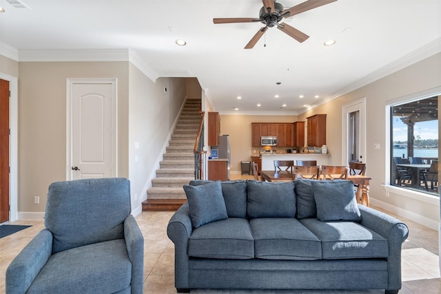 tiled living room featuring ceiling fan, a water view, and crown molding