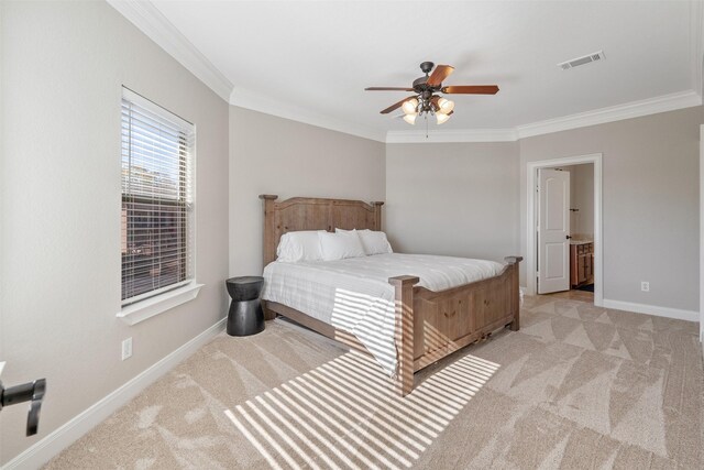 bedroom featuring light colored carpet, ensuite bath, ceiling fan, and ornamental molding