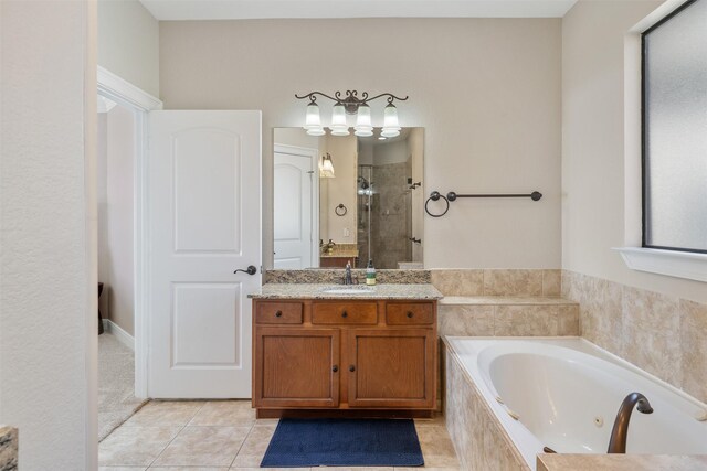 bathroom featuring vanity, shower with separate bathtub, and tile patterned floors