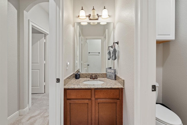 bathroom with toilet and vanity