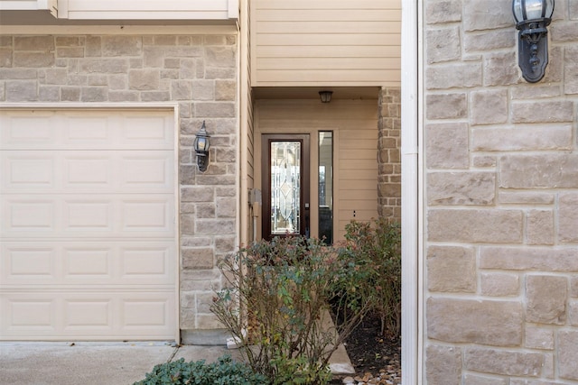 doorway to property with a garage