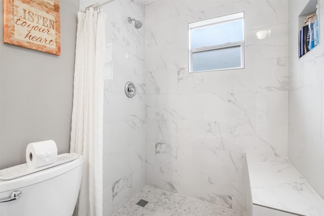 bathroom with a shower with curtain and toilet