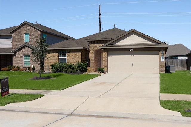 view of front of house with a front yard, brick siding, driveway, and an attached garage