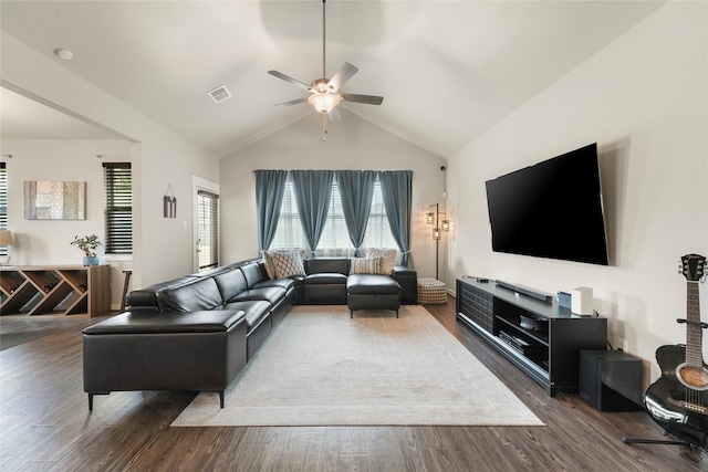 living room featuring ceiling fan, vaulted ceiling, dark hardwood / wood-style flooring, and a healthy amount of sunlight