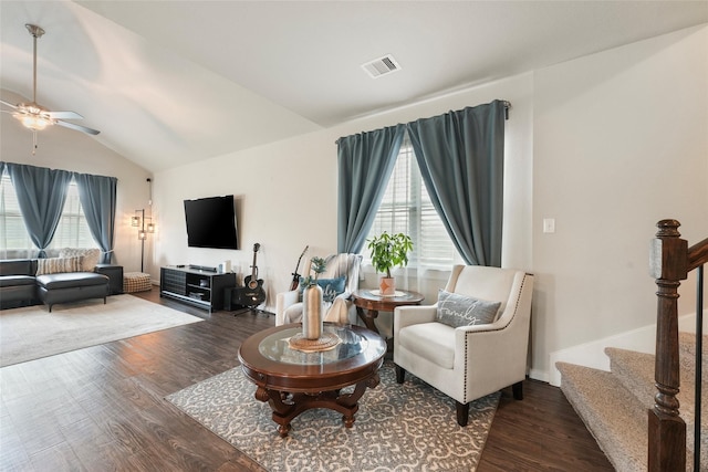 living room featuring vaulted ceiling, dark hardwood / wood-style floors, and a healthy amount of sunlight