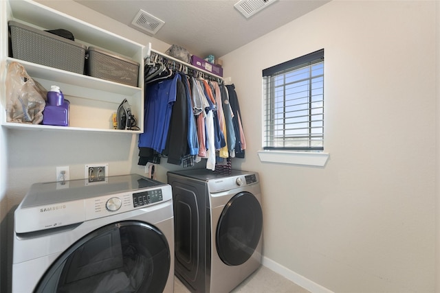 laundry area featuring washing machine and clothes dryer