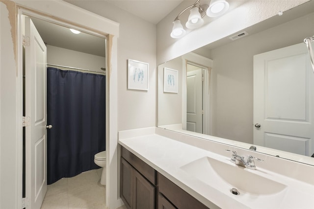 bathroom with vanity, toilet, and tile patterned flooring