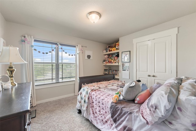 bedroom with a closet and light carpet