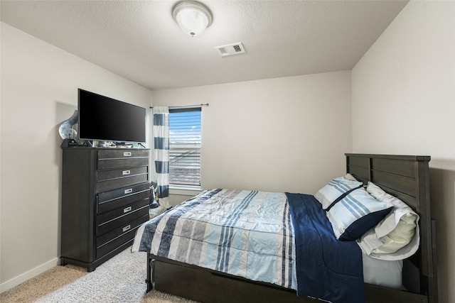 carpeted bedroom with a textured ceiling