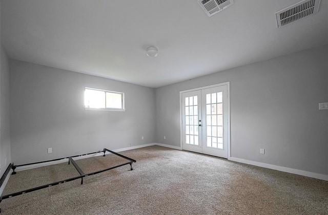 spare room with a wealth of natural light and french doors