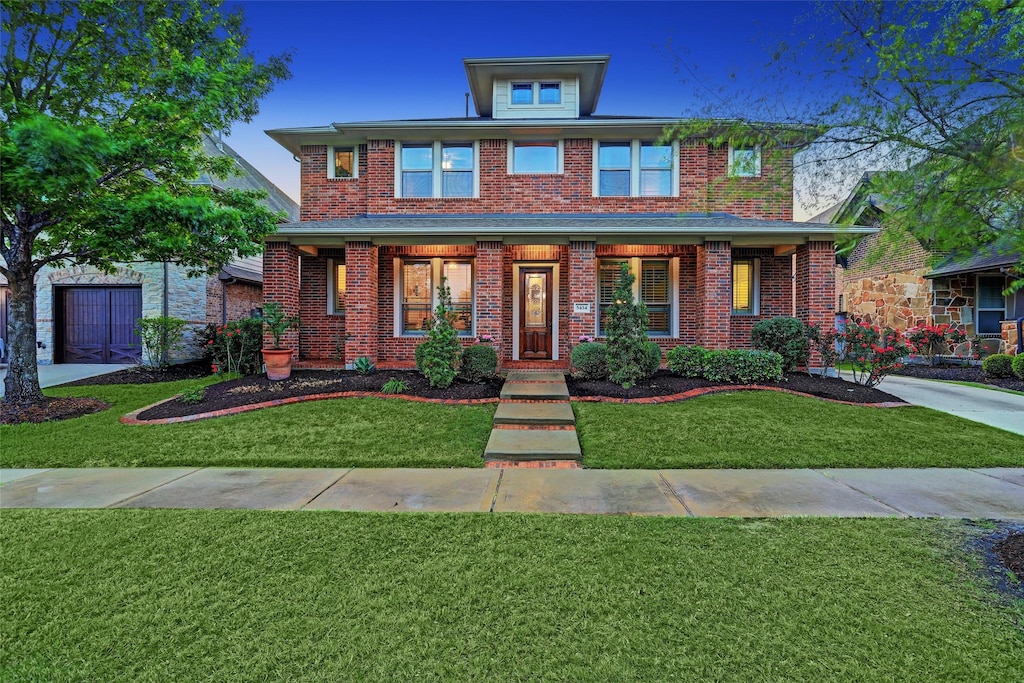 view of front of home with covered porch and a front lawn