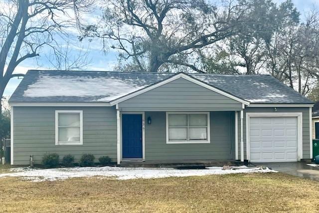 single story home featuring a garage and a front lawn