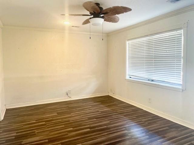 spare room featuring ornamental molding, dark wood-type flooring, baseboards, and a ceiling fan